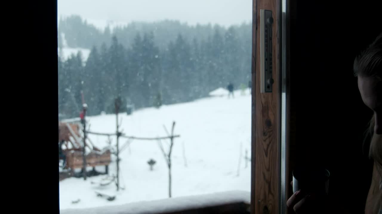 Stock Footage Woman Drinking Coffee By The Window On A Snowy Day Live Wallpaper Free