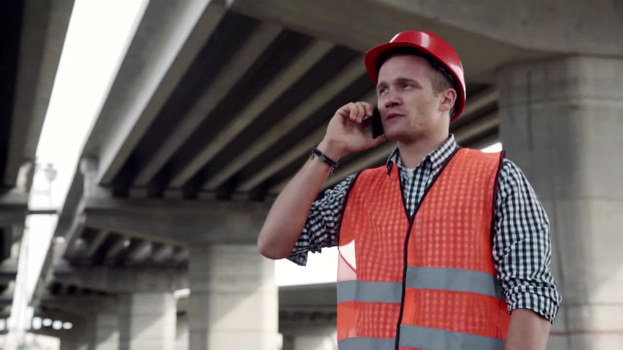 Stock Footage Young Construction Worker Talking On The Phone Live Wallpaper Free