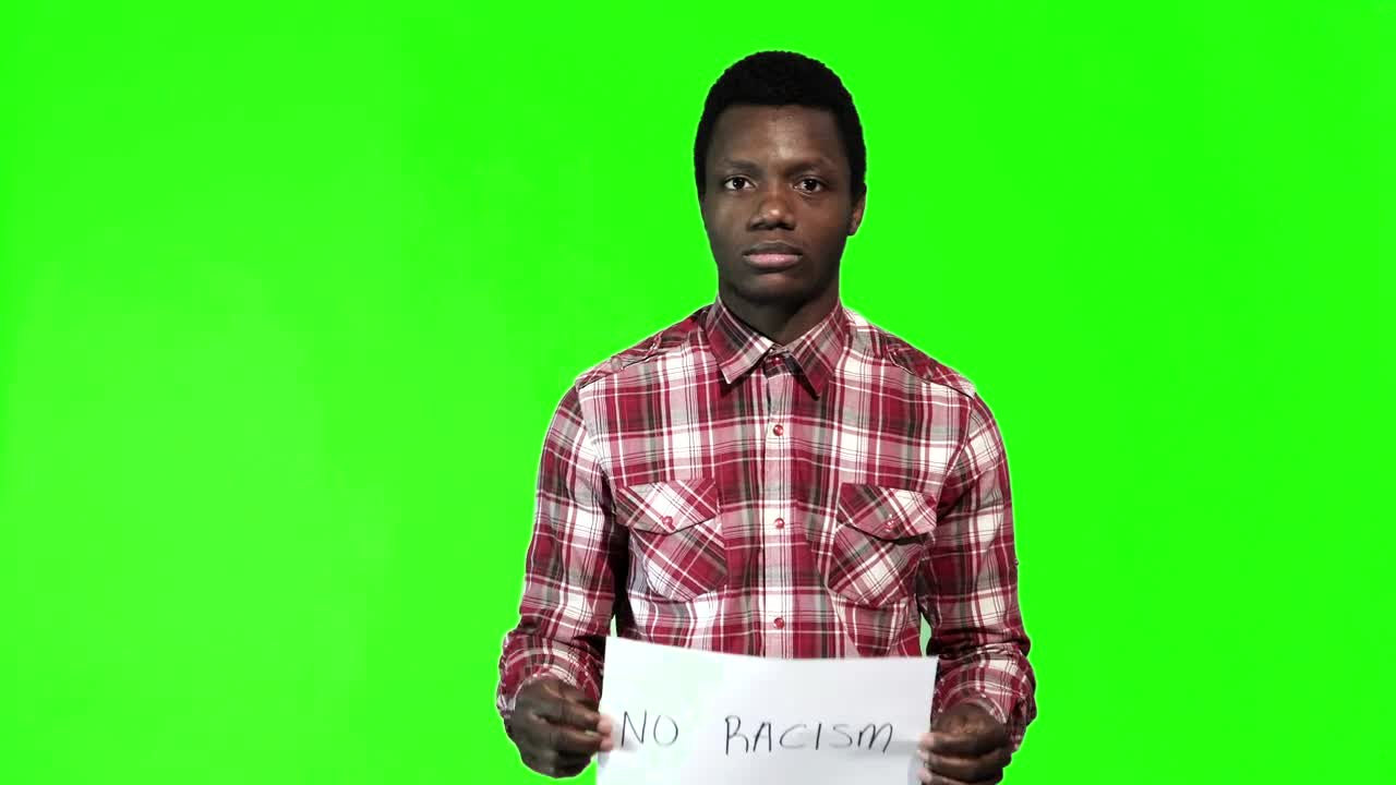 Stock Footage Young Man Holding A Sign Of No Racism Live Wallpaper Free