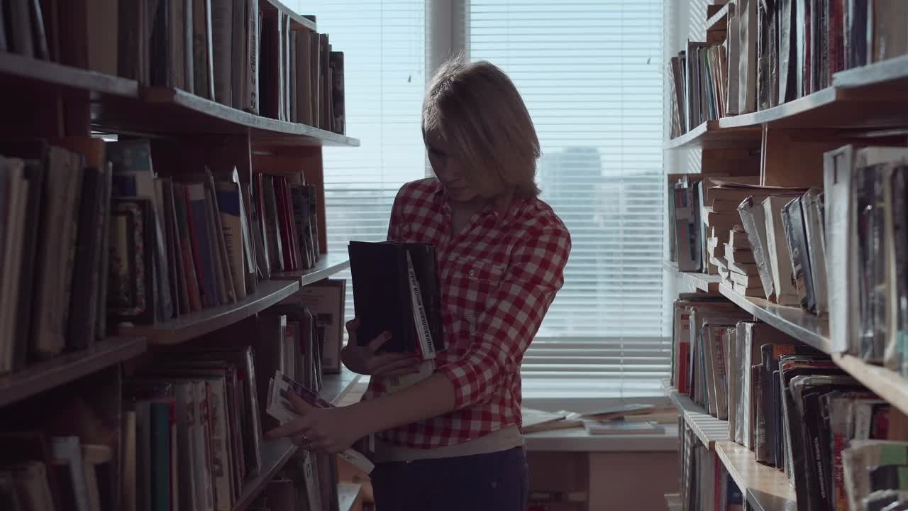 Stock Footage Young Woman Arranging The Books At The Library Live Wallpaper Free