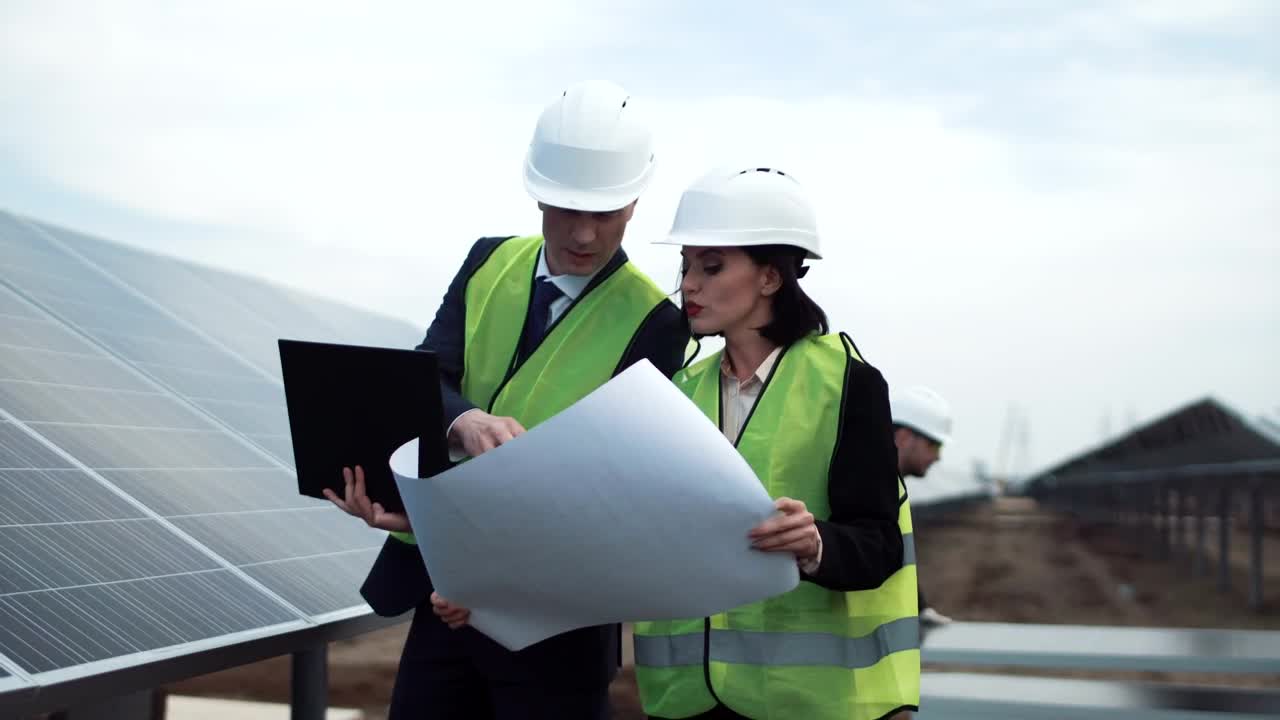 Stock Footage Workers Checking A Blueprint In The Solar Field Live Wallpaper Free