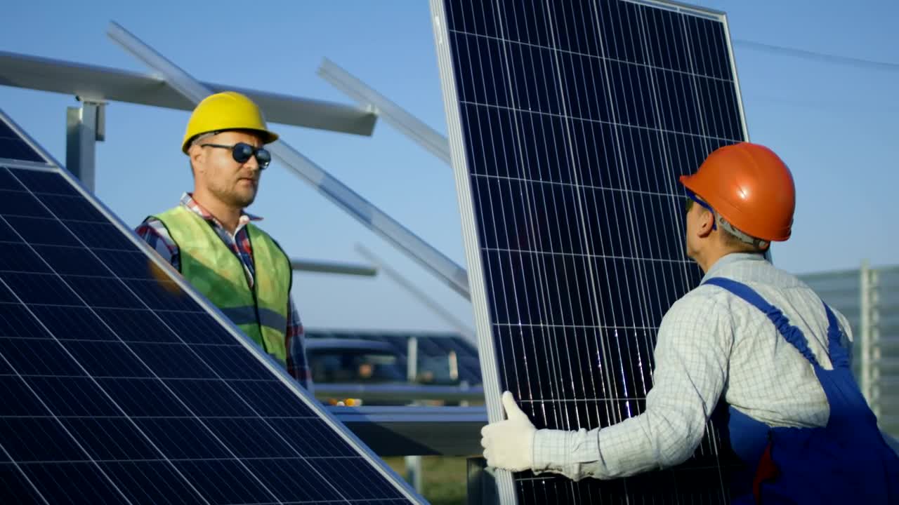 Stock Footage Workers Installing A Solar Panel Outdoors Live Wallpaper Free