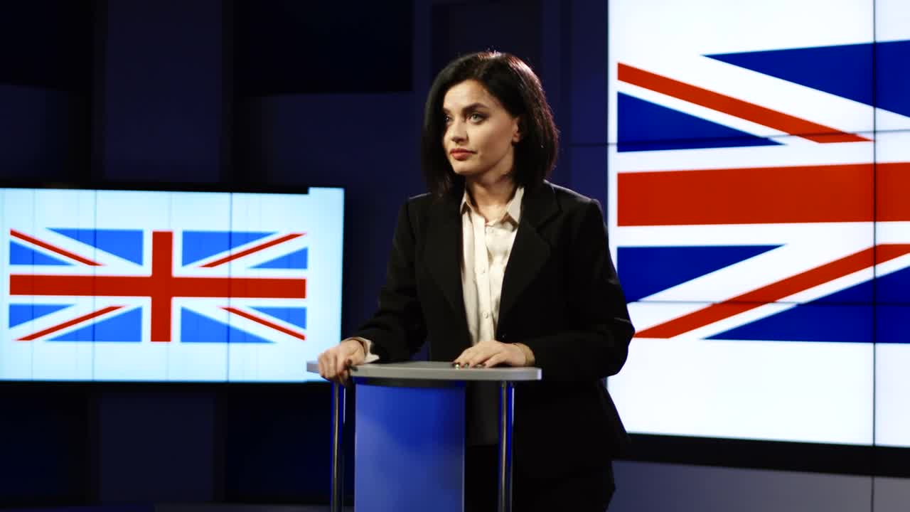 Stock Footage Young Woman Speaking With Uk Flag Behind Her Live Wallpaper Free