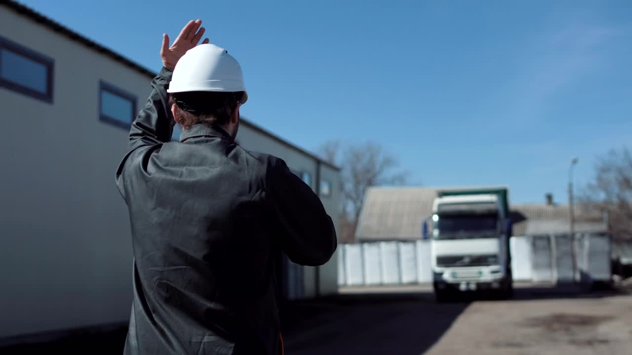 Stock Footage Worker Leading A Freight Truck In The Parking Live Wallpaper Free