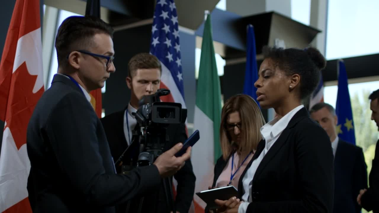 Stock Footage Woman Gives An Interview At An International Summit Live Wallpaper Free