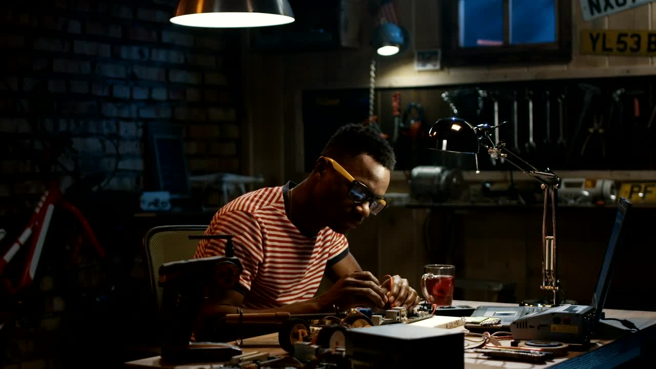 Stock Footage Young Man Repairing A Circuit On The Garage Live Wallpaper Free