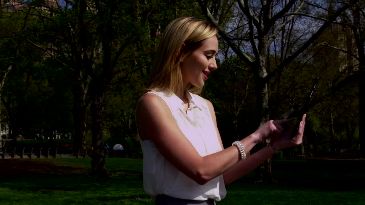 Stock Footage Woman Taking Photos In A City Park Live Wallpaper Free