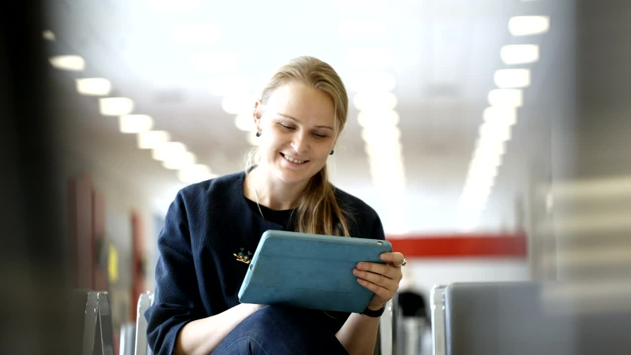 Stock Footage Woman Using A Tablet In A Waiting Room Live Wallpaper Free