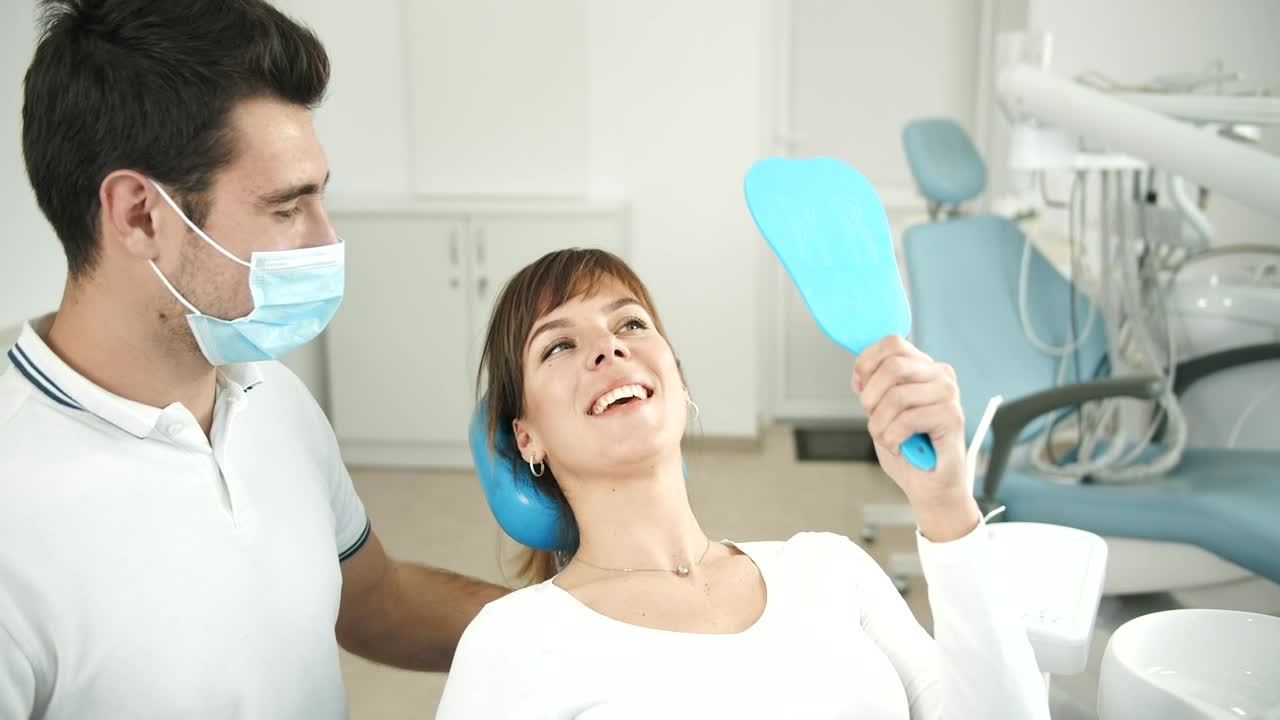 Stock Footage Woman Looks At Teeth In Dentist Office Mirror Live Wallpaper Free