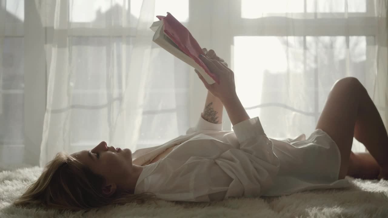 Stock Footage Woman Reading A Story Lying On The Bed Live Wallpaper Free