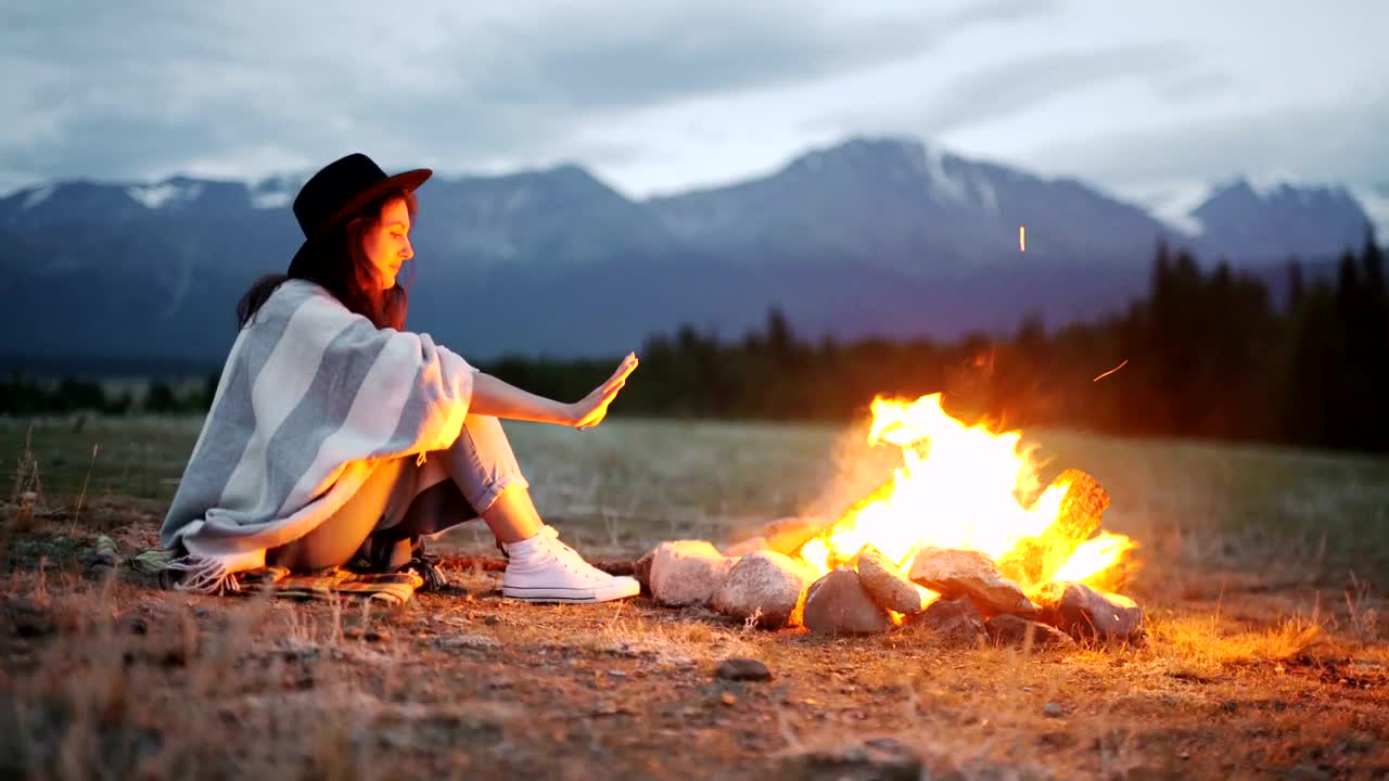 Stock Footage Woman Warming Her Hands Over A Hot Campfire Live Wallpaper Free