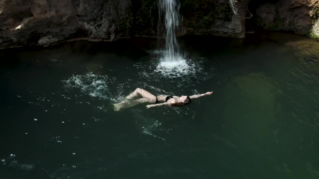 Stock Footage Woman Swimming In A Pond With A Little Waterfall Live Wallpaper Free