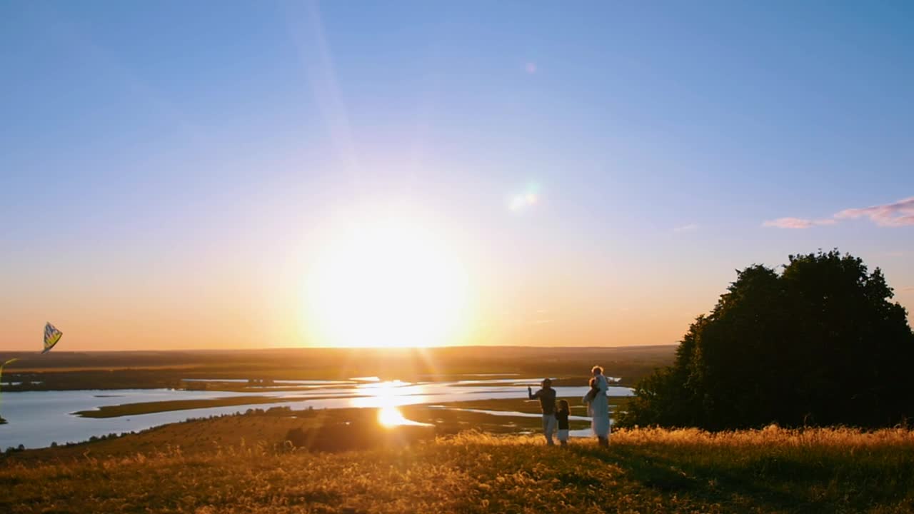 Stock Footage Young Family With Kite At Sunset Live Wallpaper Free