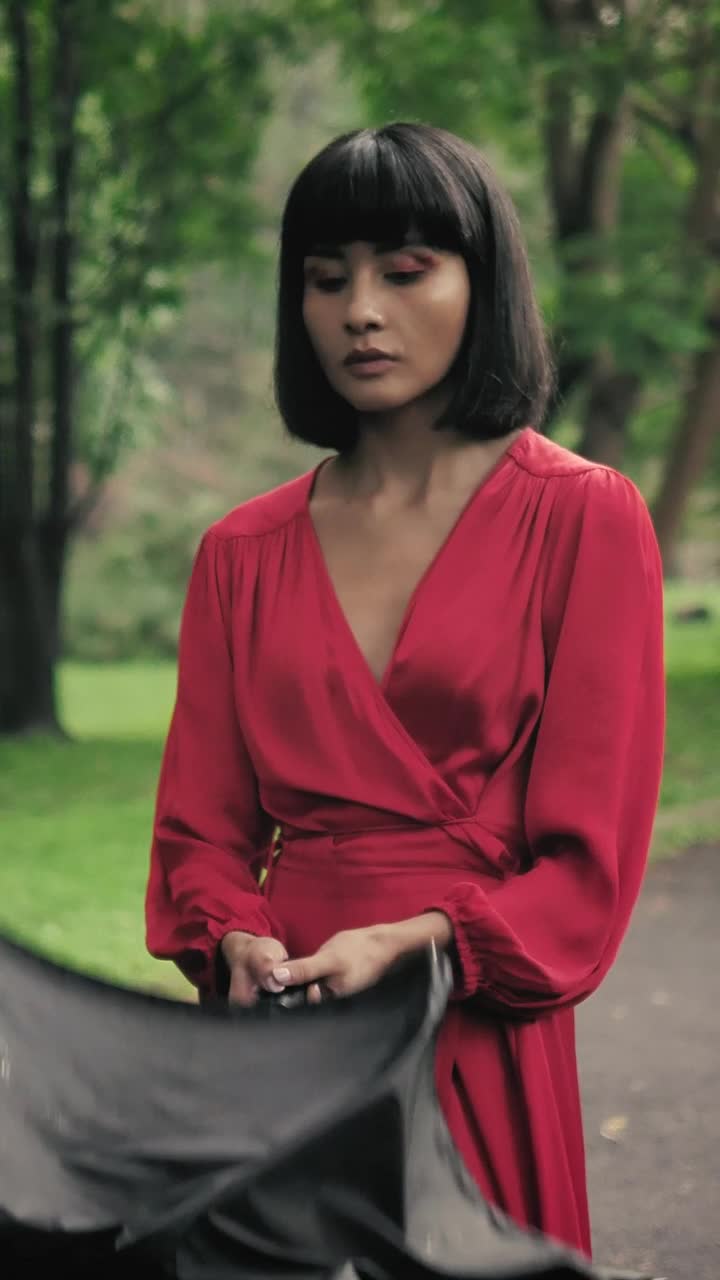 Stock Footage Young Woman In A Park Opening Her Umbrella To Cover Live Wallpaper Free