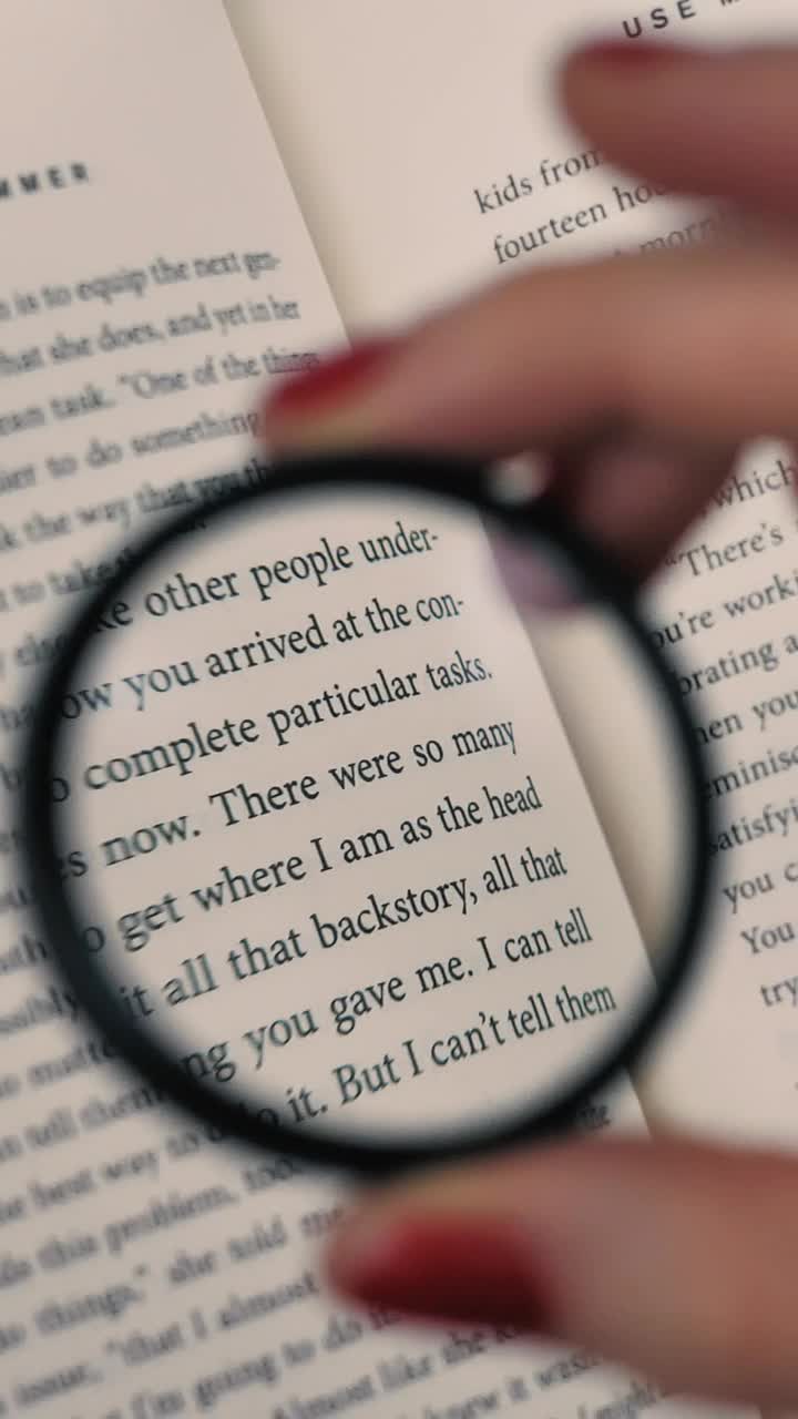 Stock Footage Woman Reading A Book Helped By A Magnifying Glass Live Wallpaper Free
