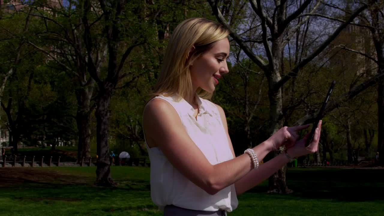 Stock Footage Woman Scrolling On A Tablet In Central Park Live Wallpaper Free