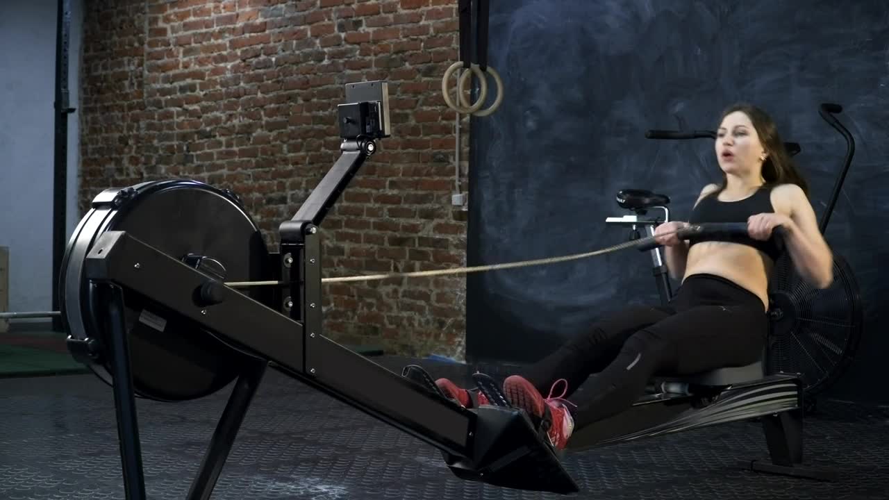 Stock Footage Woman Using A Rowing Machine Live Wallpaper Free