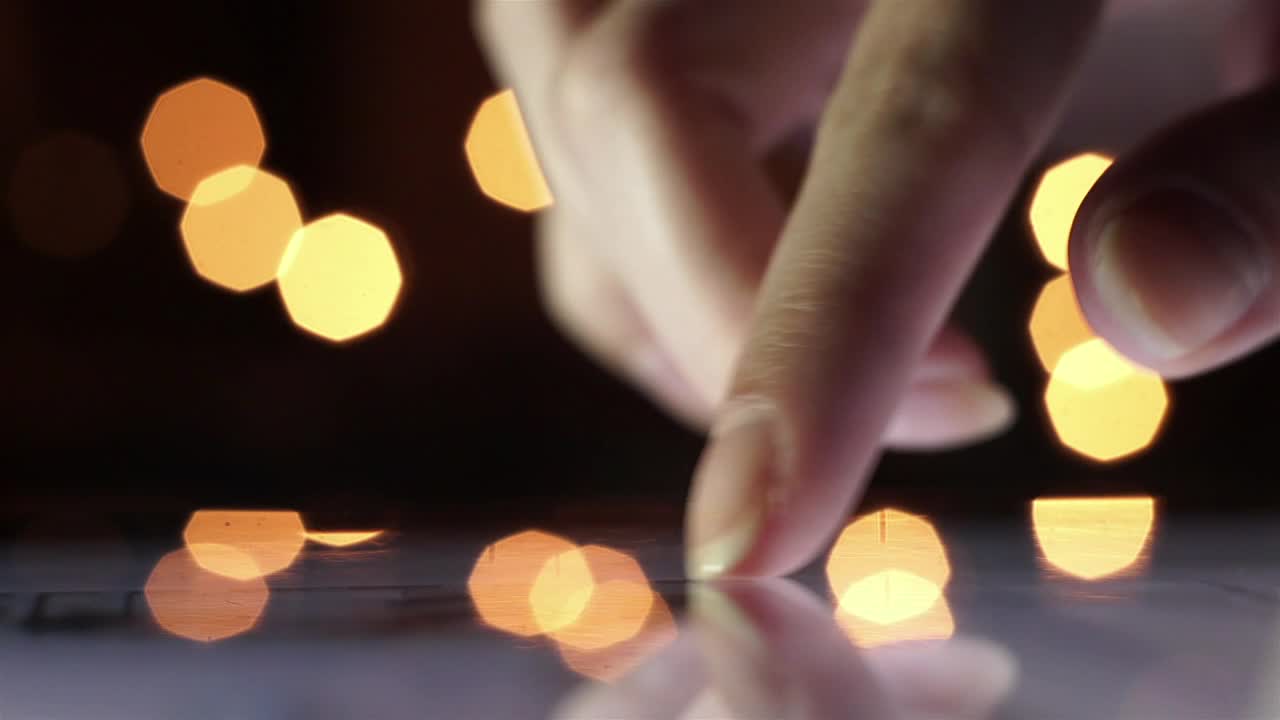 Stock Footage Womans Finger Scrolling Tablet Surface With Bokeh Backgound Live Wallpaper Free