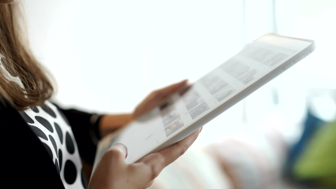 Stock Footage Woman Scrolls Through Instagram Photos On Tablet Live Wallpaper Free