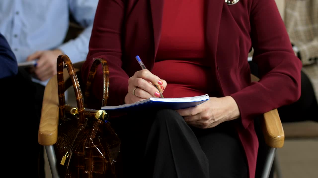 Stock Footage Writing In A Notepad At A Conference Live Wallpaper Free