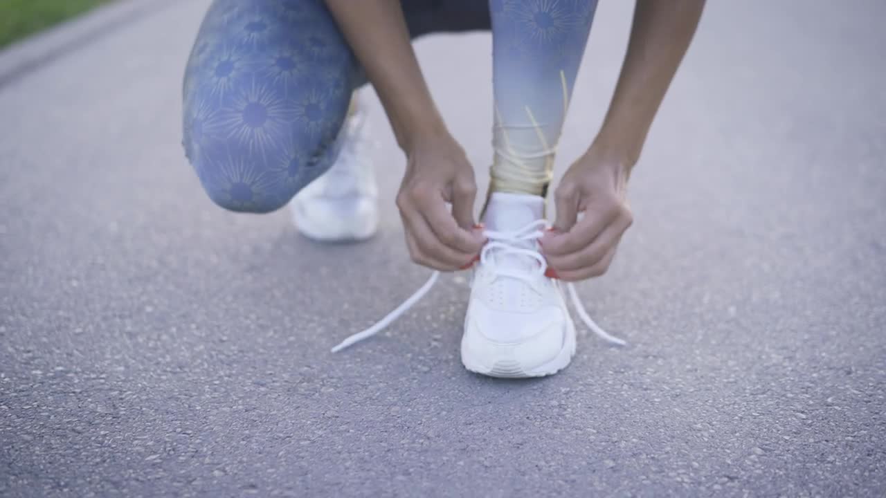 Stock Footage Woman Tying The Laces Of Her Sneakers Live Wallpaper Free