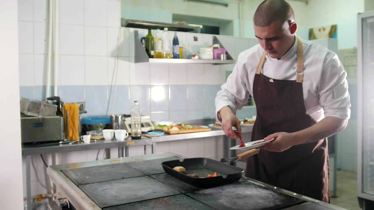 Stock Footage Young Chef Preparing A Meal In The Kitchen Live Wallpaper Free
