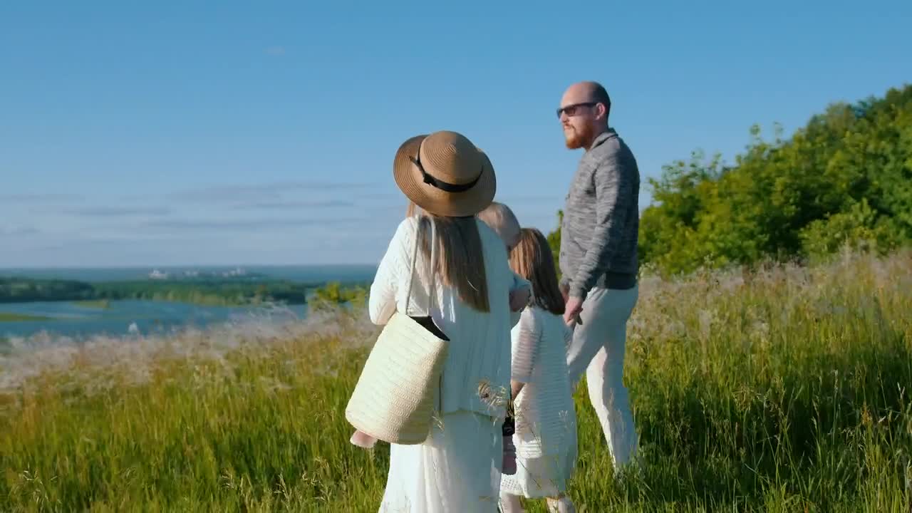 Stock Footage Young Family Walking Down The Hill To The River Live Wallpaper Free