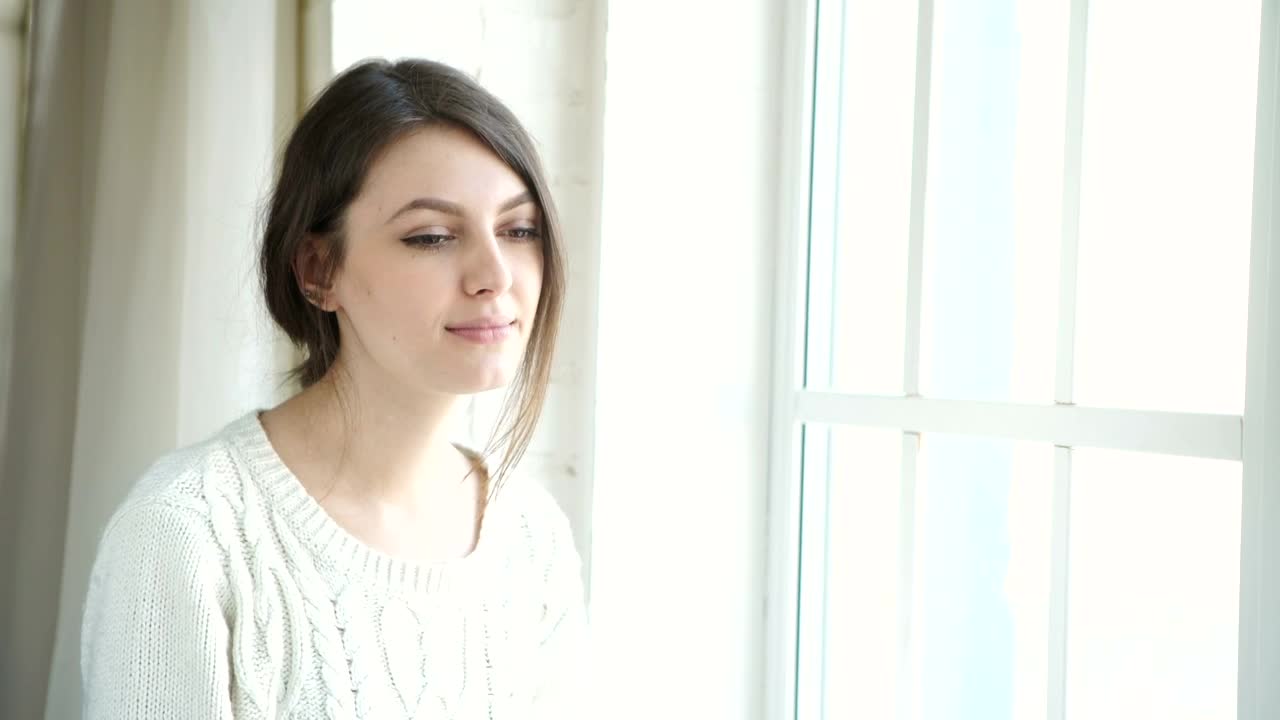 Stock Footage Young Woman Sips Tea Near Bright Sunny Window Live Wallpaper Free