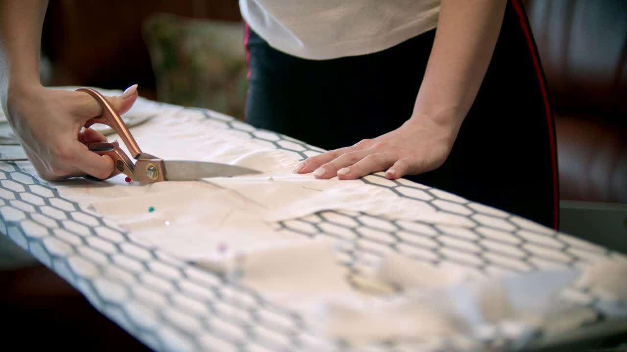 Stock Footage Young Woman Cutting White Fabric With Scissors Live Wallpaper Free