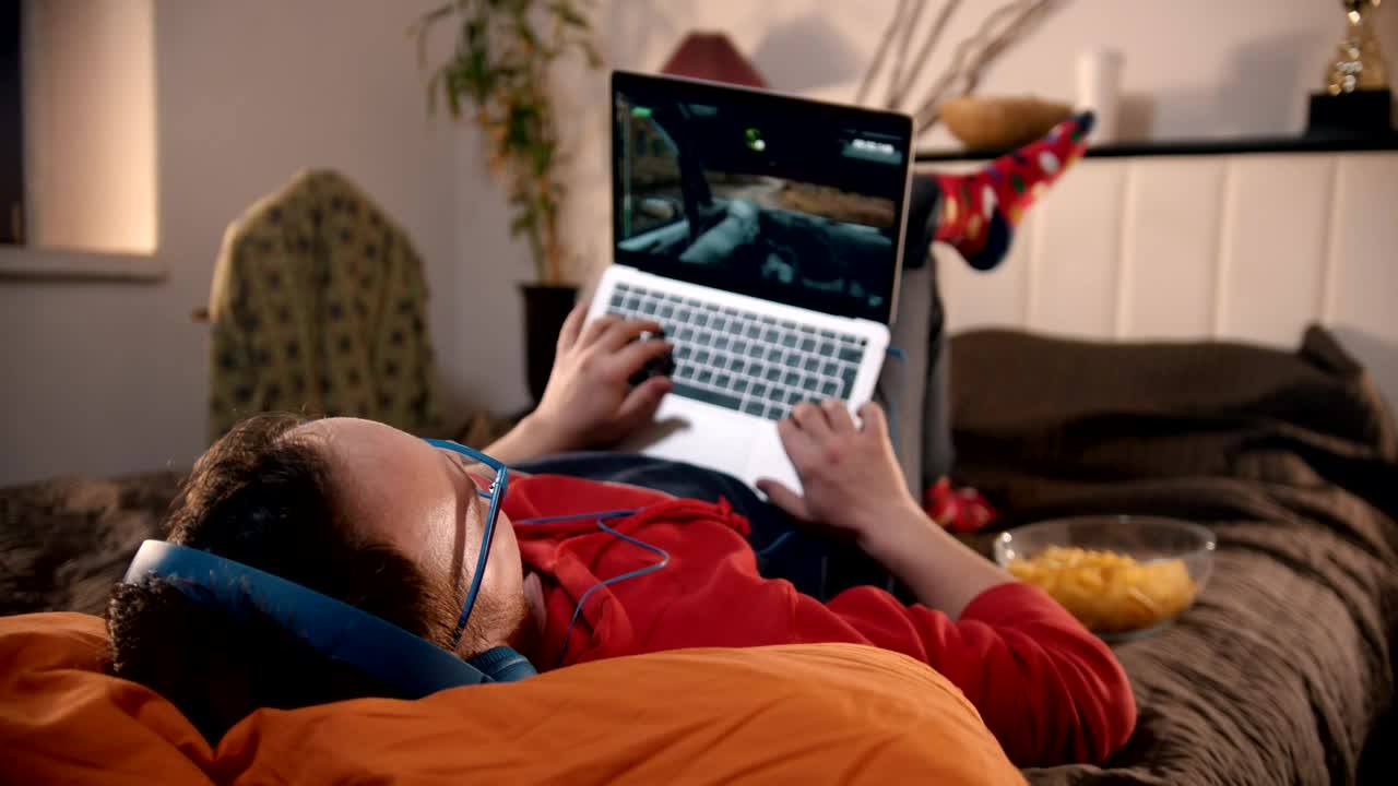 Stock Footage Young Man Lying On The Bed Playing Video Games On Live Wallpaper Free