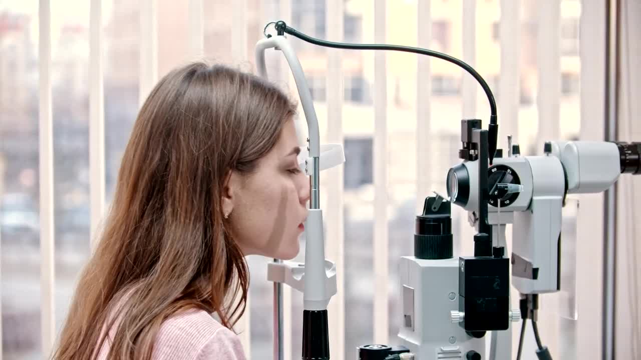 Stock Footage Woman Putting Chin On A Modern Vision Test Device Live Wallpaper Free