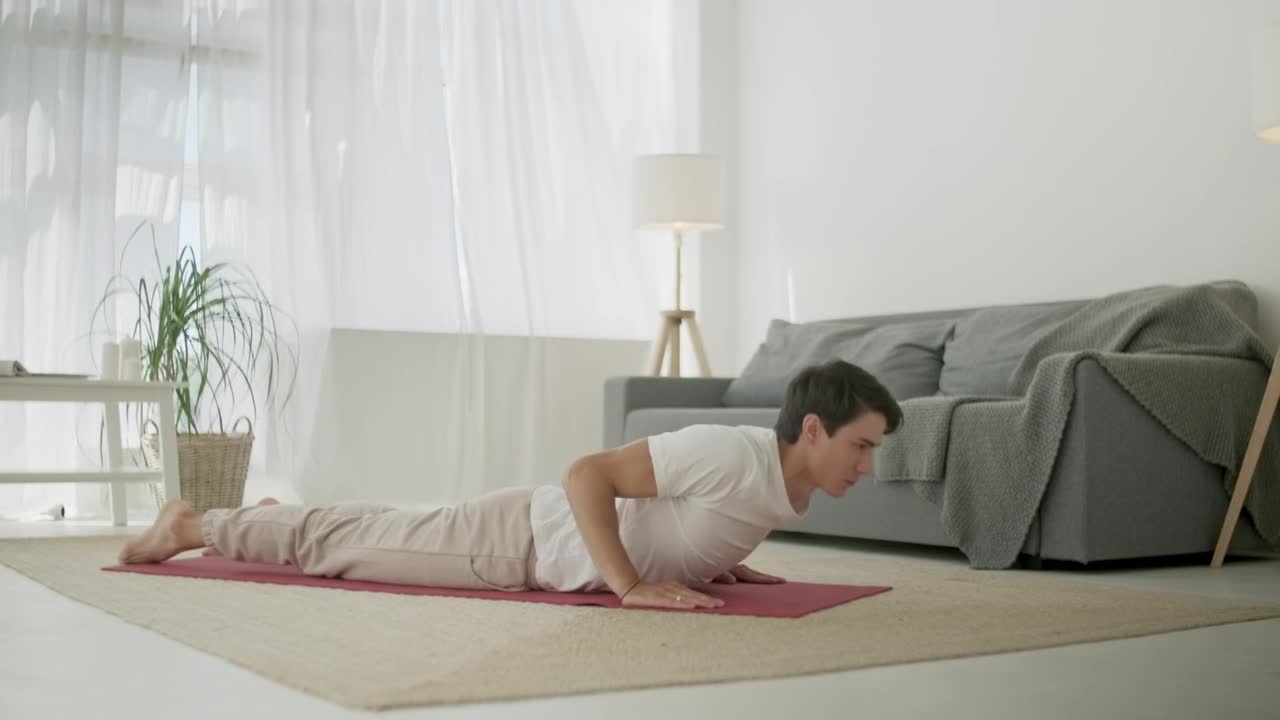 Stock Footage Young Man Doing Yoga Routine At Home In Living Room Live Wallpaper Free