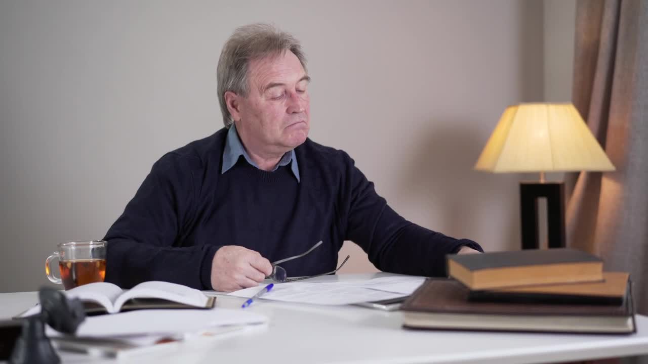 Stock Footage Writer Looks Over Manuscript Pages And Shakes Head Live Wallpaper Free