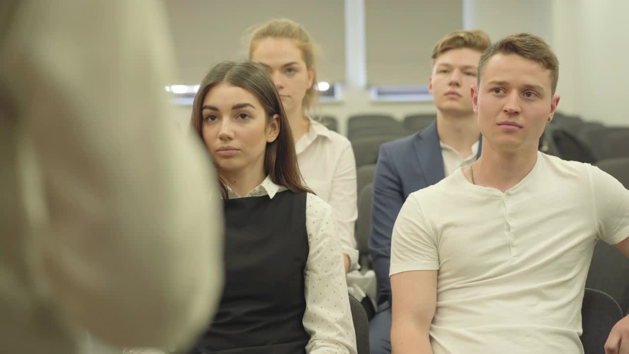 Stock Footage Young Business People Listen To Lecture In Conference Room Live Wallpaper Free