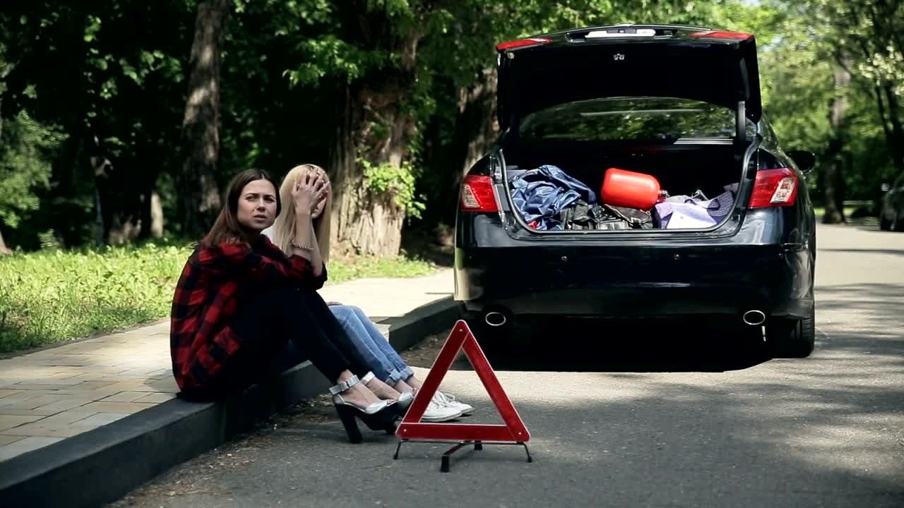 Stock Footage Young Women Sit On Curb After Auto Accident Live Wallpaper Free
