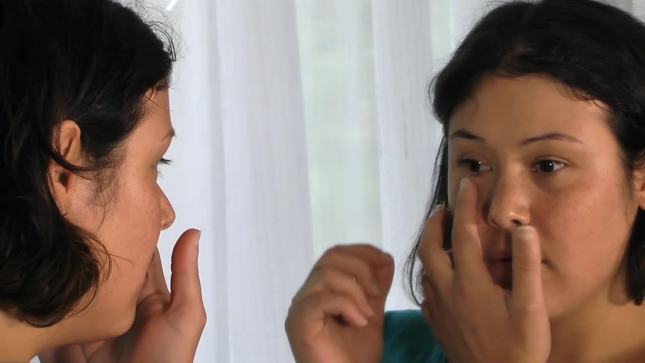 Stock Footage Woman Removing A Prosthesis Eye In The Mirror Live Wallpaper Free