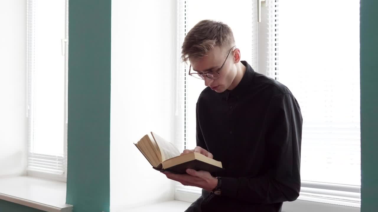 Stock Footage Young Man Reading Against The Window Live Wallpaper Free