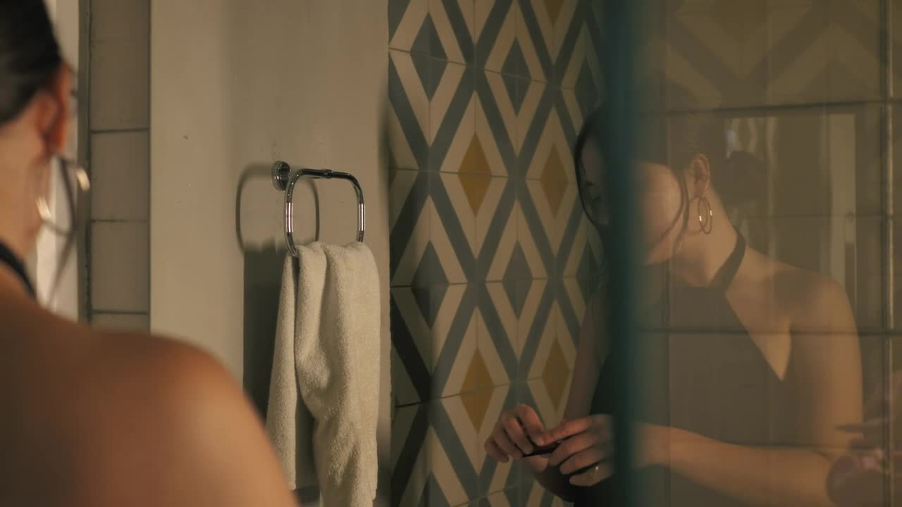 Stock Footage Woman Putting On Lipstick In Front Of A Bathroom Mirror Live Wallpaper Free