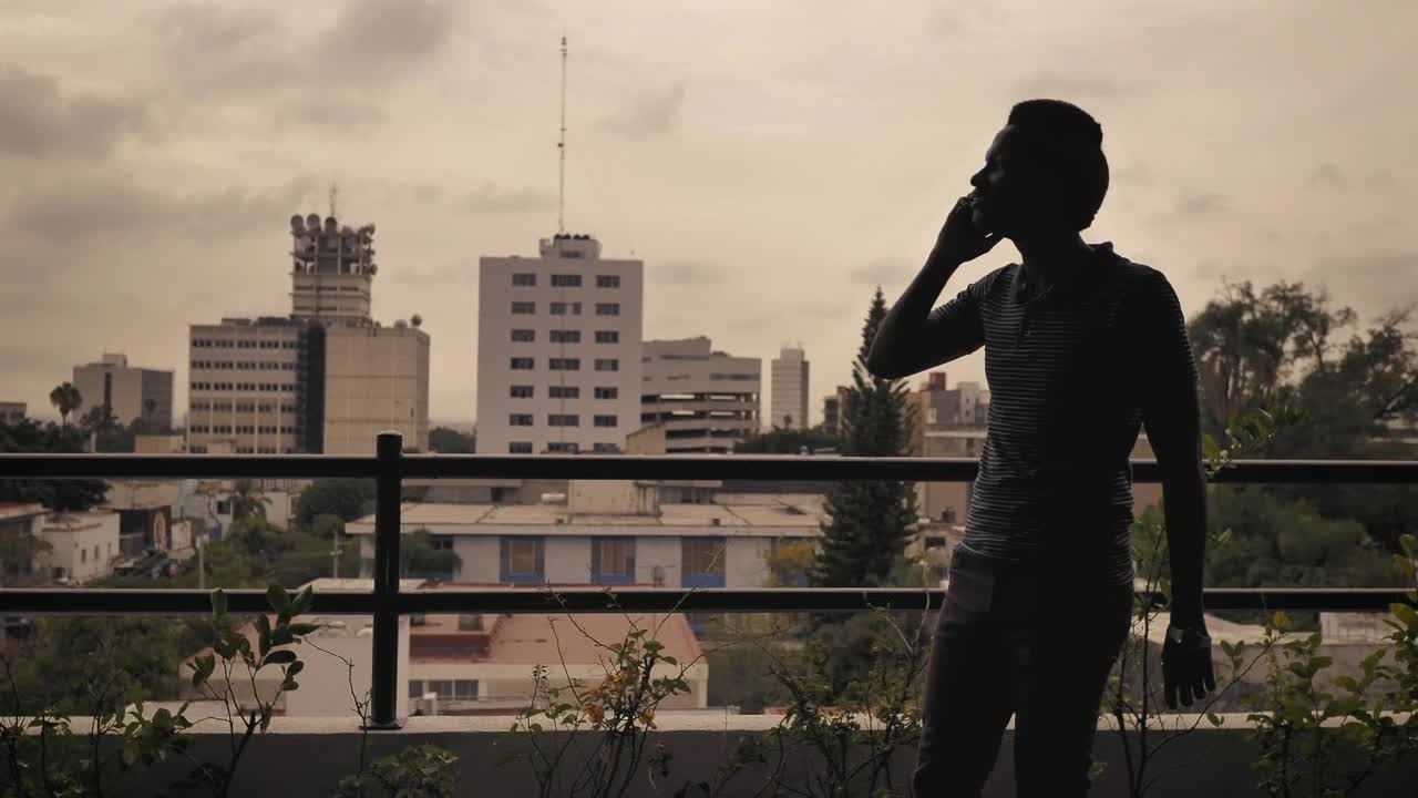 Stock Footage Young Man Having A Call On A Balcony Live Wallpaper Free