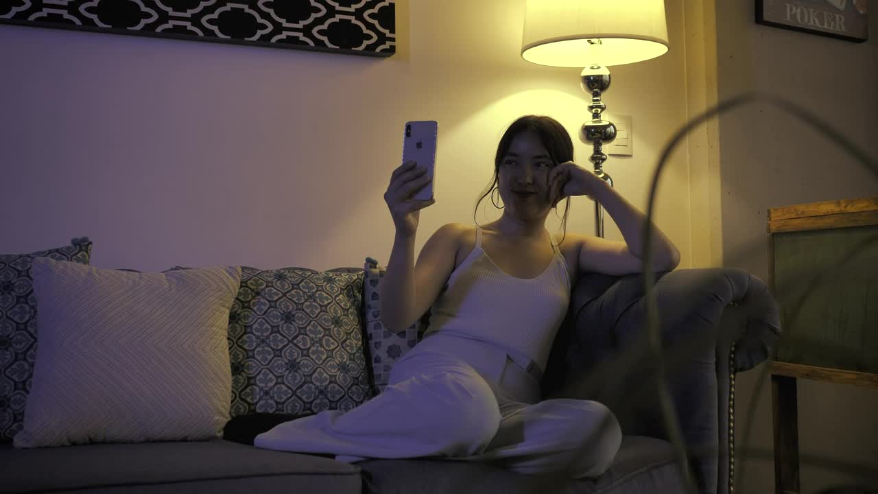 Stock Footage Woman Resting On A Sofa While Talking On Video Call Live Wallpaper Free