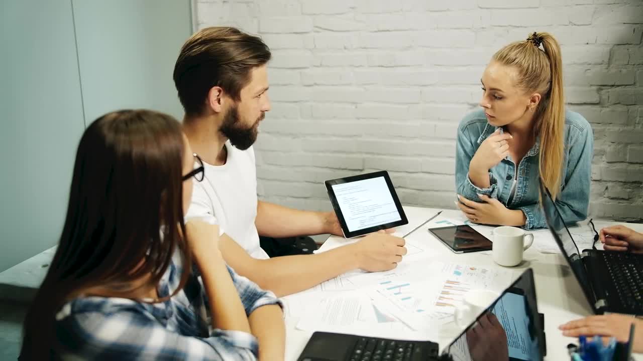 Stock Footage Young Team Brainstorm With Tablet At Meeting Live Wallpaper Free
