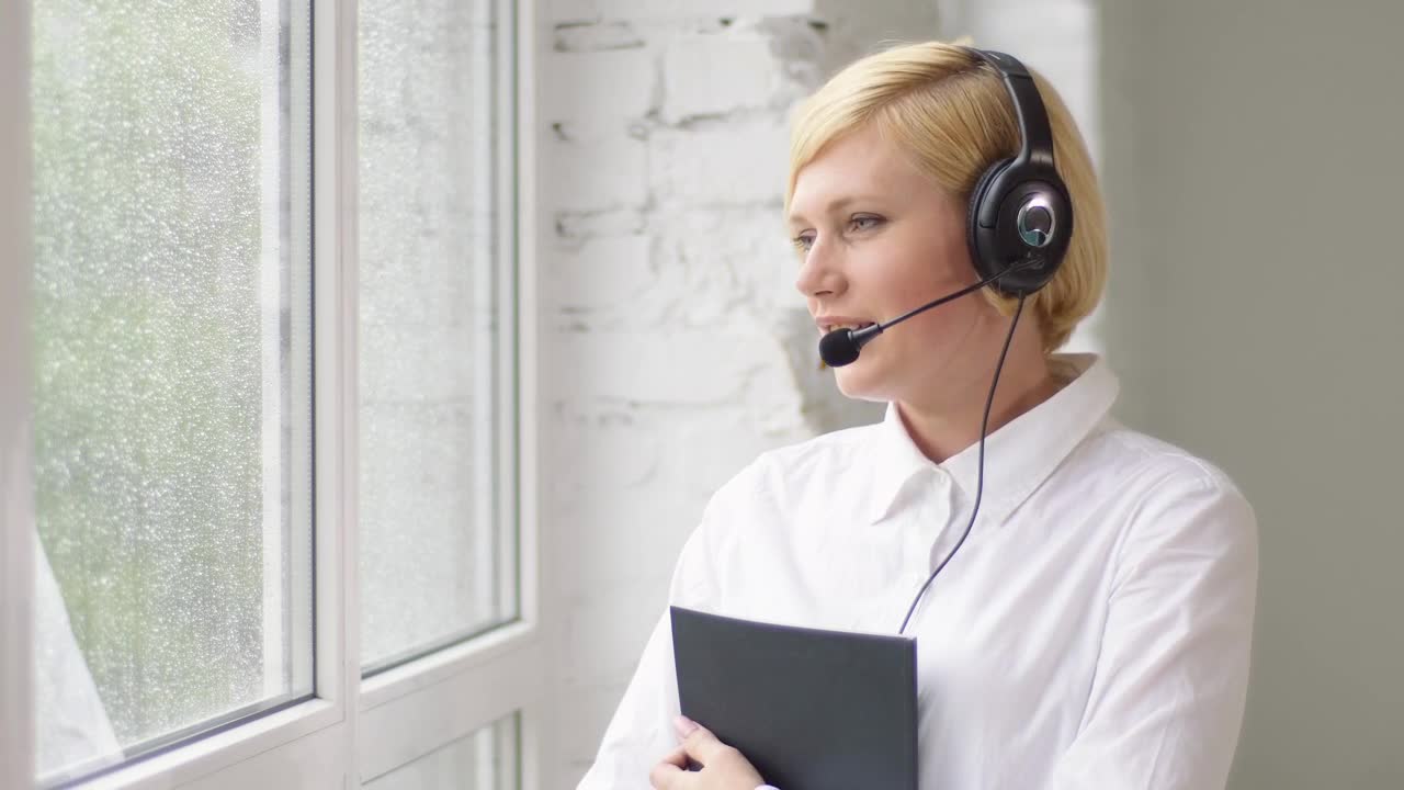 Stock Footage Woman Helping Customers Remotely By Bright Window Live Wallpaper Free