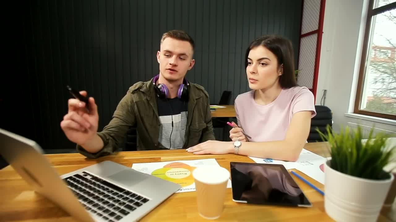 Stock Footage Young Man Explains Idea To Partner And Points To Laptop Live Wallpaper Free