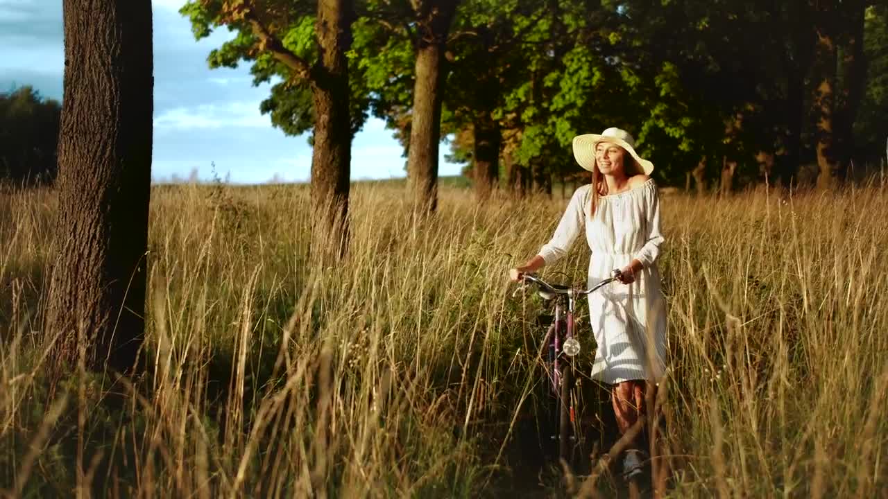 Stock Footage Woman Walking Bicycle Through Field Enjoys Afternoon Sun Live Wallpaper Free