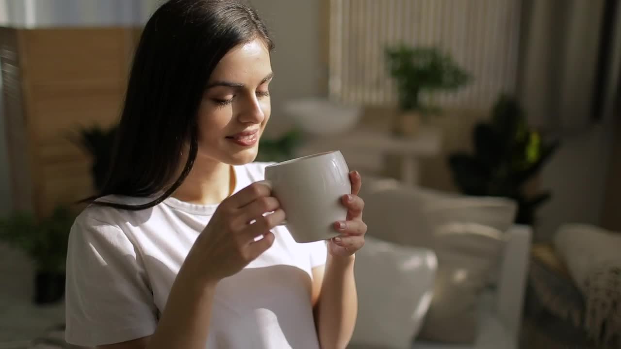 Stock Footage Woman Enjoys Cup Of Coffee And Smiles Live Wallpaper Free