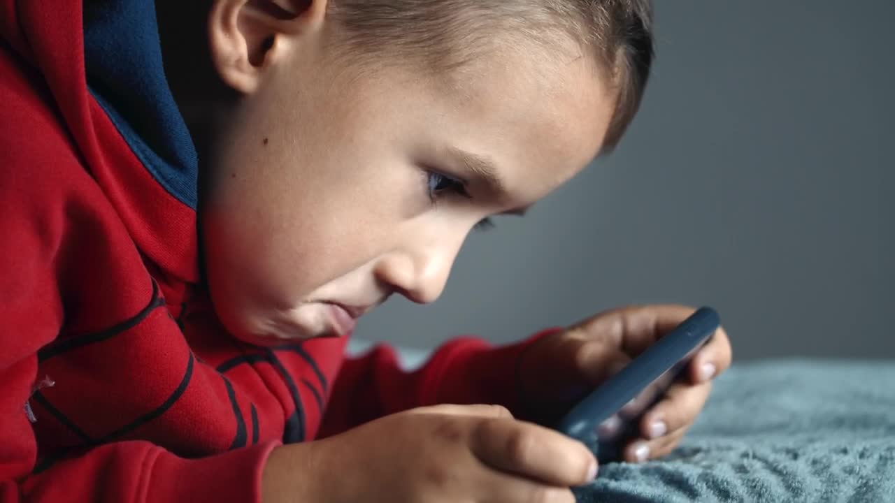 Stock Footage Young Boy Playing Mobile Video Games On Bed Live Wallpaper Free
