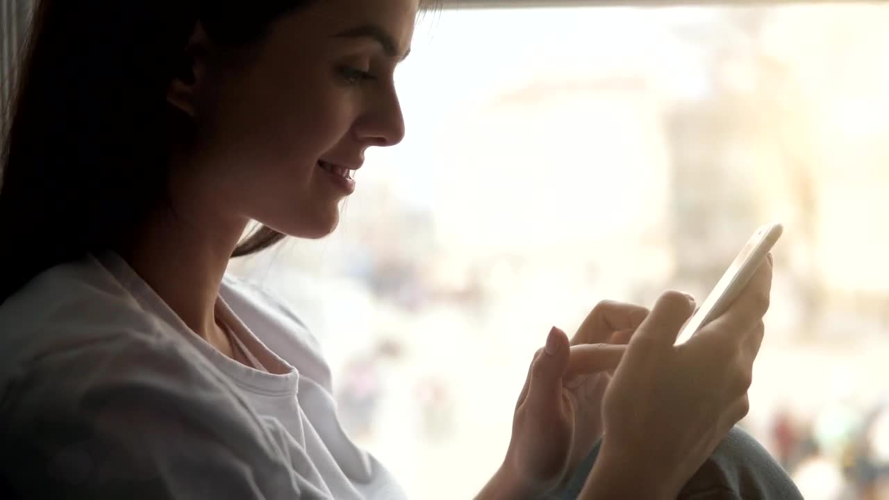 Stock Footage Woman Smiles While Using Mobile App Live Wallpaper Free