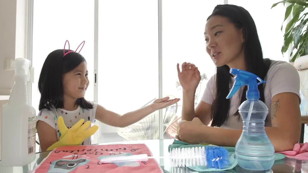 Stock Footage Young Mother Putting Cleaning Gloves On Her Daughter Live Wallpaper Free
