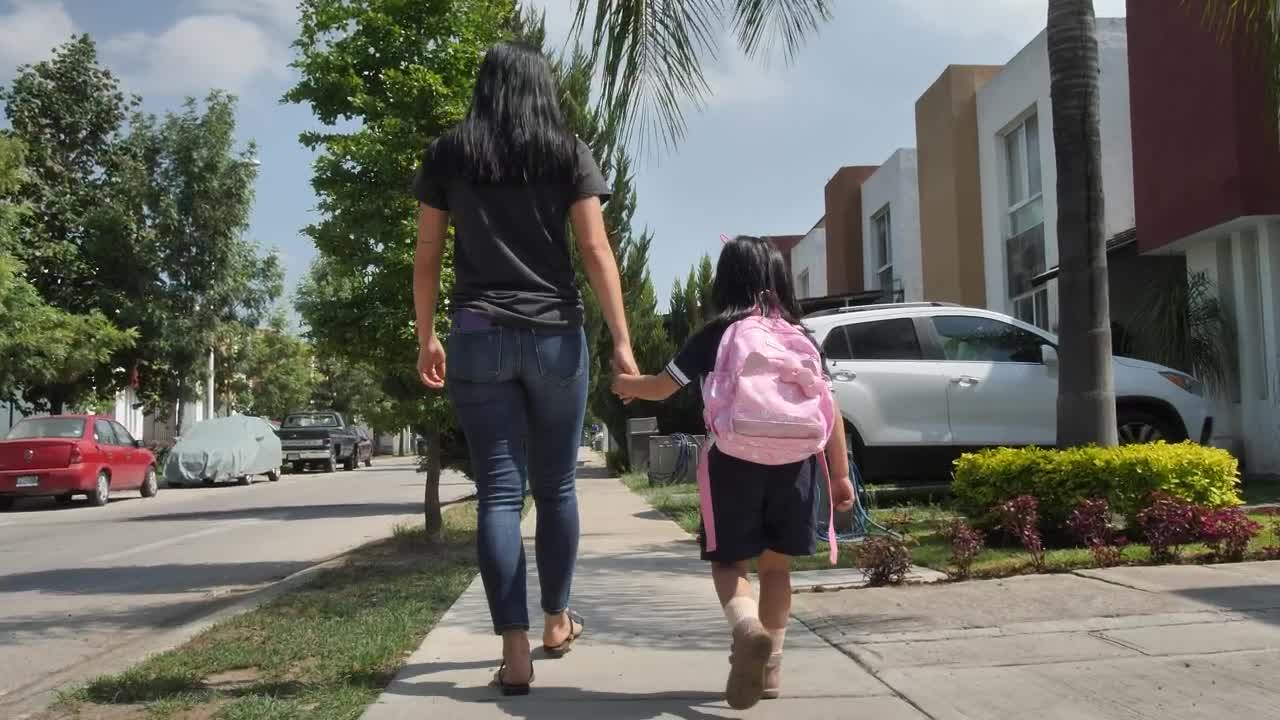Stock Footage Woman With Her Little Daughter Walking On The Sidewalk Live Wallpaper Free