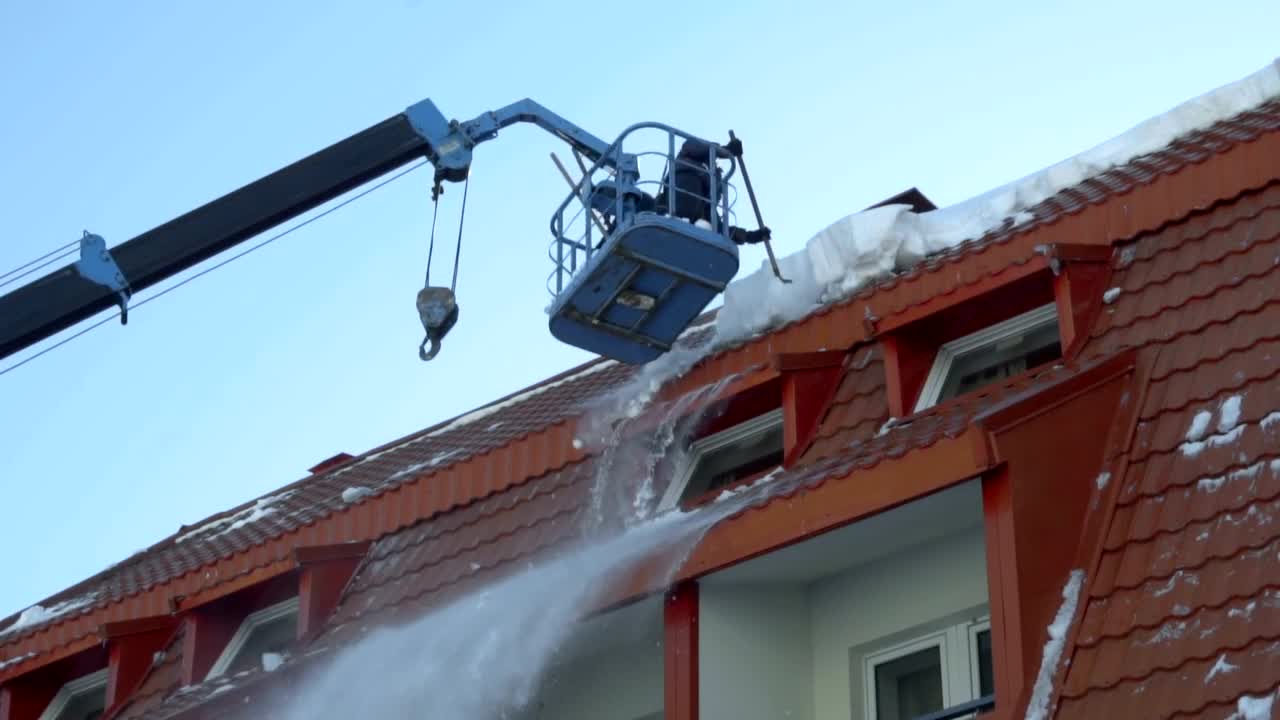 Stock Footage Worker Removing Snow On The Roof Of The Building Live Wallpaper Free